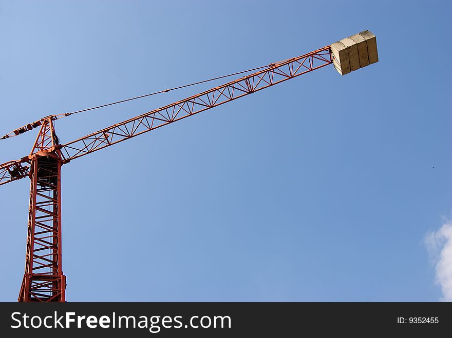 Tall crane against blue sky