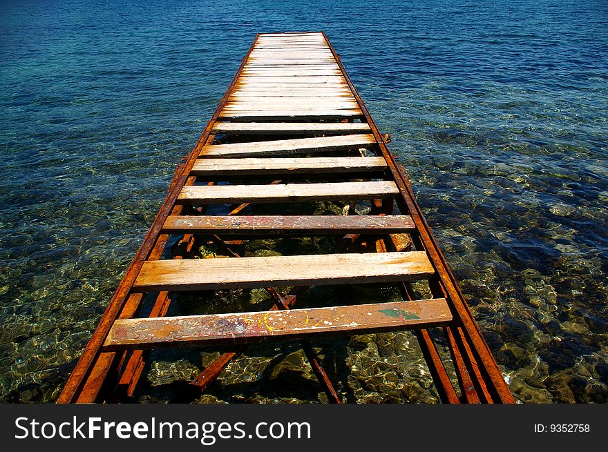 A wooden - metal jetty on the sea. A wooden - metal jetty on the sea