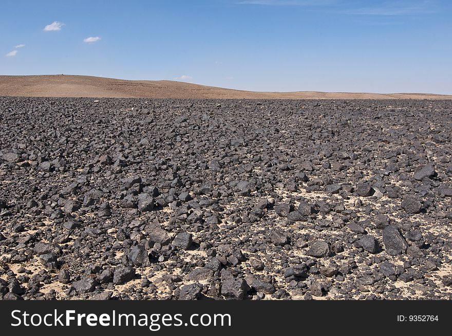 Black roscks in desert