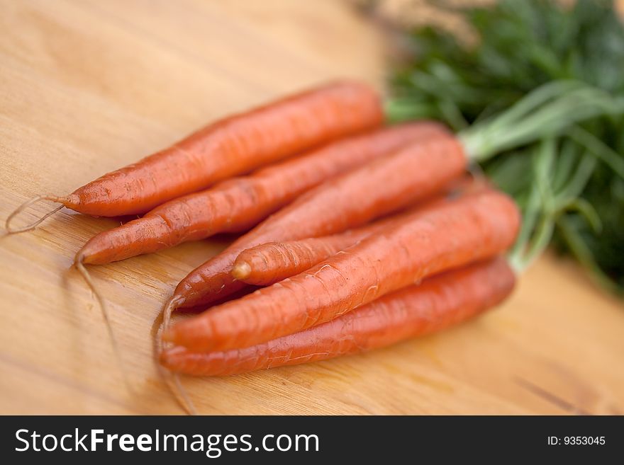 Bunches of fresh carrots for sale at a market