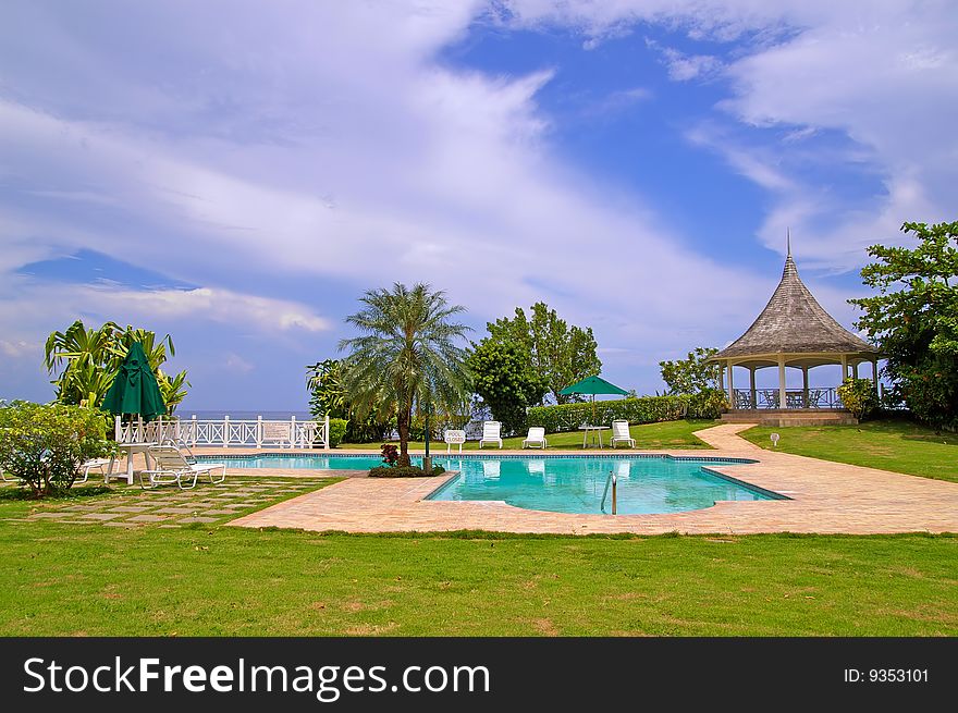 Swimming pool at beachfront property with blue sky