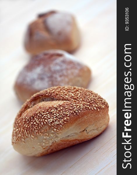 Many buns with sesame seeds , macro shot.