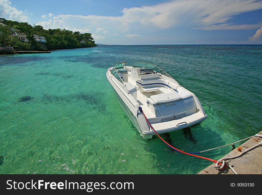 Pleasure boat docked in a tropical harbor