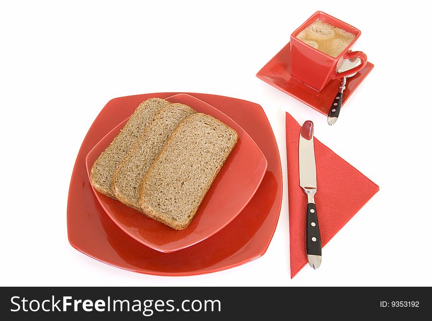 Breakfast arrangement with bread and coffee cup isolated on white background