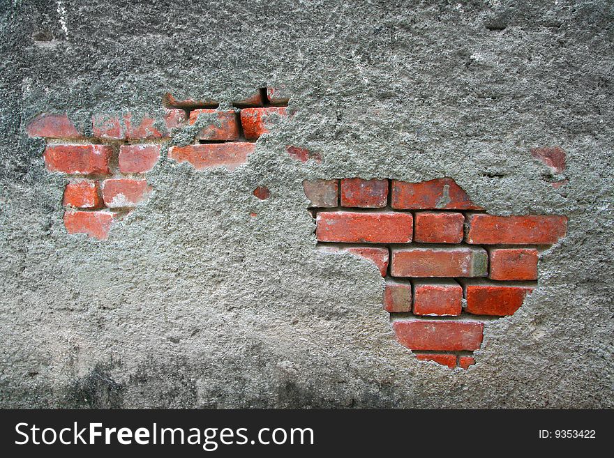 Deteriorating concrete and redbrick building