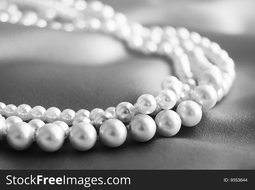 Three strands of pearls on satin. Three strands of pearls on satin