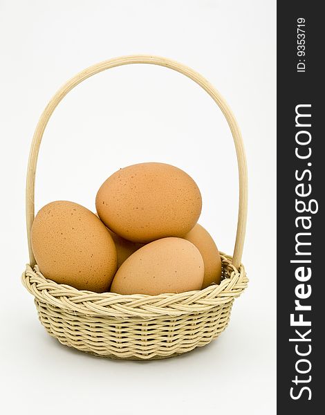 Eggs in a basket on a white background. Eggs in a basket on a white background