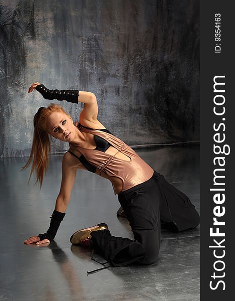 Modern style dancer posing on studio background. Modern style dancer posing on studio background