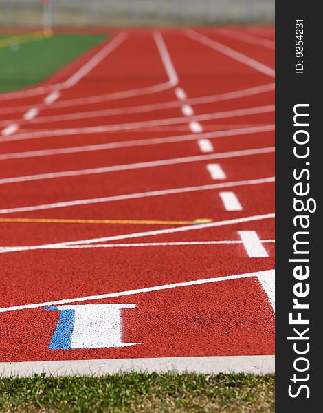 Red field track with numbers and lines in white. Red field track with numbers and lines in white.