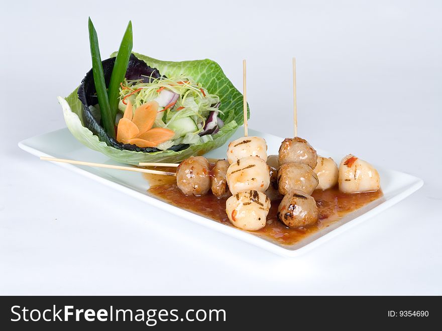 Chicken and beef meatballs with a salad isolated on a white background