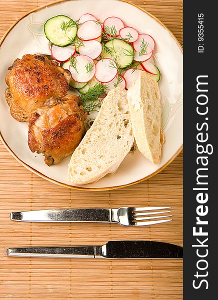 Herb Baked chicken served with a cucumber radish salad and artisan bread. Herb Baked chicken served with a cucumber radish salad and artisan bread