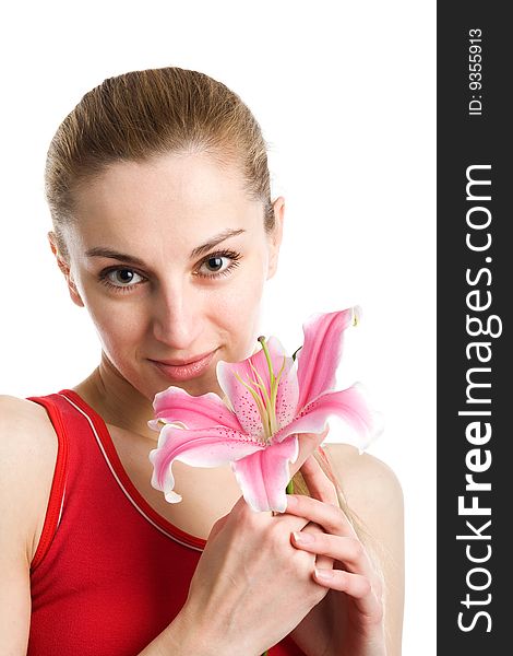 A portrait of a nice girl in red with a pink lily near her face on a white background. A portrait of a nice girl in red with a pink lily near her face on a white background