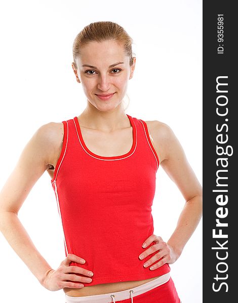 A smiling sporty blonde in red leotard posing on a white background. A smiling sporty blonde in red leotard posing on a white background