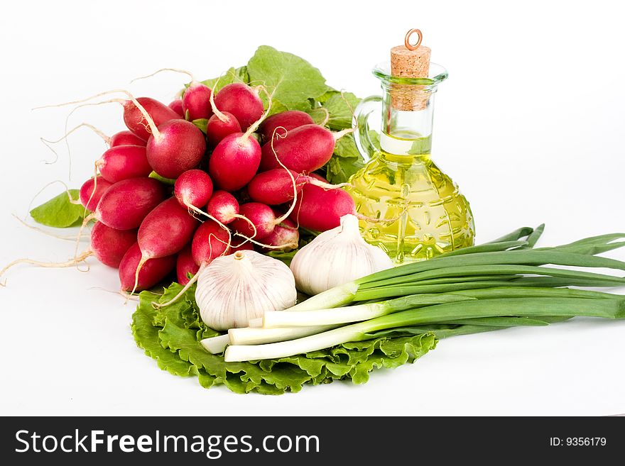 Green vegetables and a bottle of olive oil on the white background. Green vegetables and a bottle of olive oil on the white background