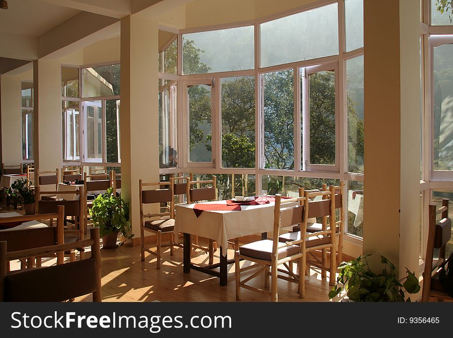 View of dining hall in a restaurant with glass windows to enjoy surrounding nature