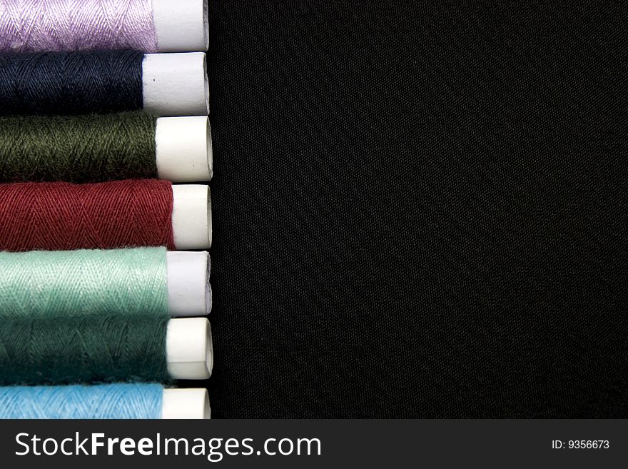 Variety of color threads with black background