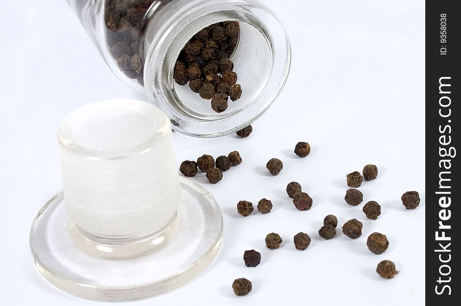 Black pepper with glass and white backgound