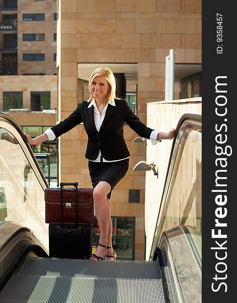 Portrait of mid adult businesswoman on escalator, looking at camera