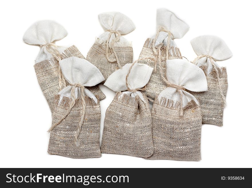 Sac pervaded spice and tied rope on white background