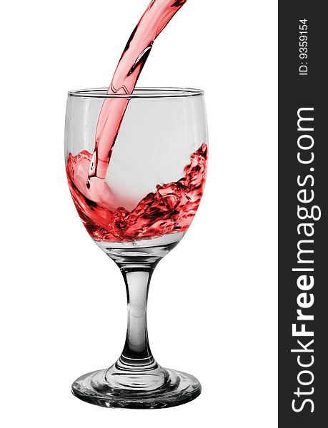 Glass with pouring red wine