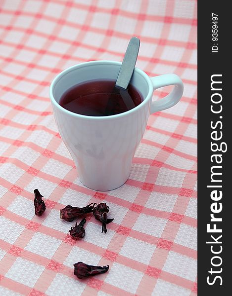 White cup with useful flower tea. White cup with useful flower tea.