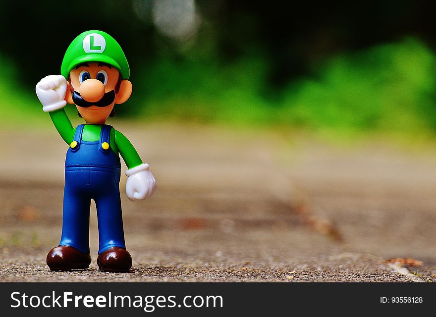 Shallow Focus Photography of Luigi Plastic Figure