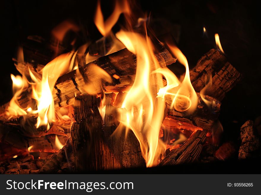 A fireplace with burning cinders and coals.