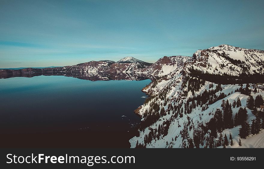 A lake in the mountains covered in snow. A lake in the mountains covered in snow.