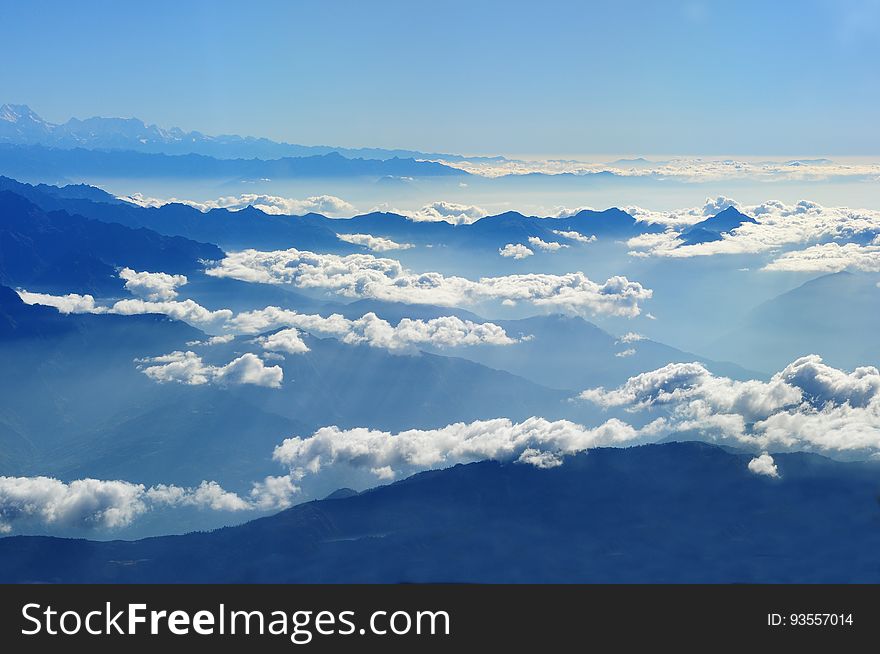 Scenic View of Clouds over Mountains Against Blue Sky