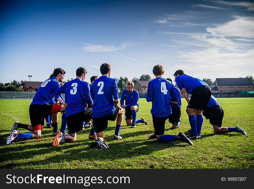 A soccer team planning their moves before the game or during a time out. A soccer team planning their moves before the game or during a time out.