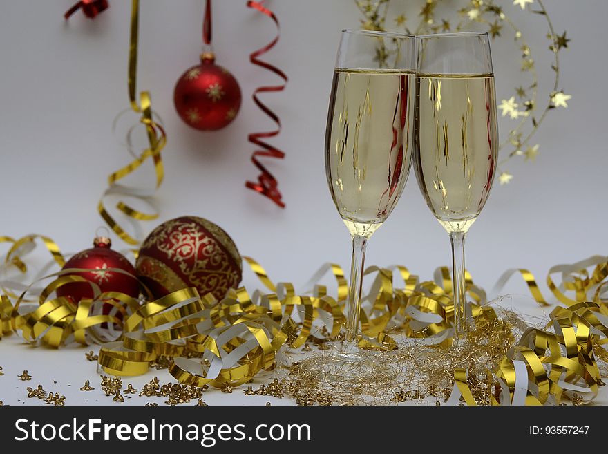 A pair of glasses of sparkling wine with Christmas and holiday decorations. A pair of glasses of sparkling wine with Christmas and holiday decorations.