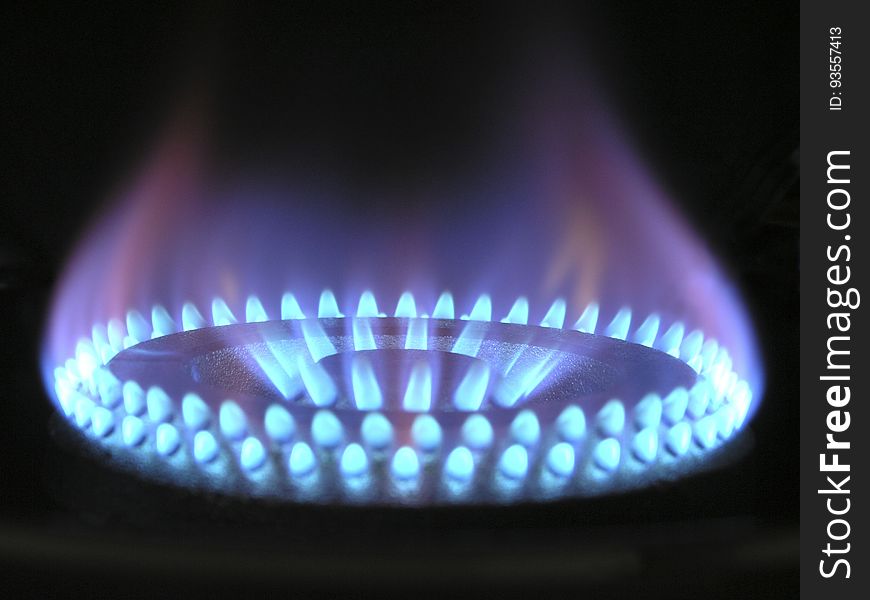 A burning gas burner with blue flame.
