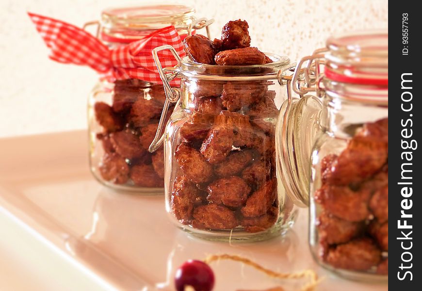 Home baked sweet nuts in transparent jars. Home baked sweet nuts in transparent jars.