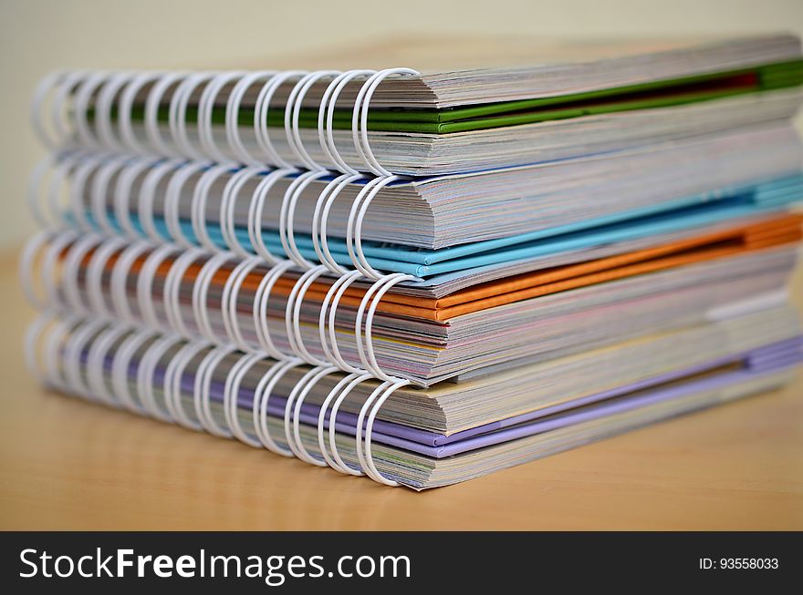 A stack of books with spring or coil binders. A stack of books with spring or coil binders.