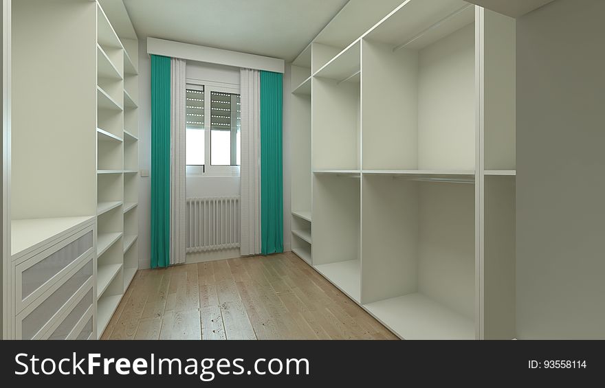 A view inside a walk-in-closet in a modern apartment. A view inside a walk-in-closet in a modern apartment.