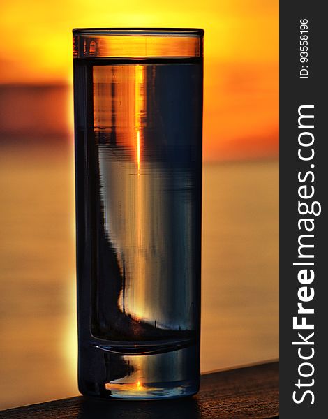 Glass Of Water Illuminated By A Sunset