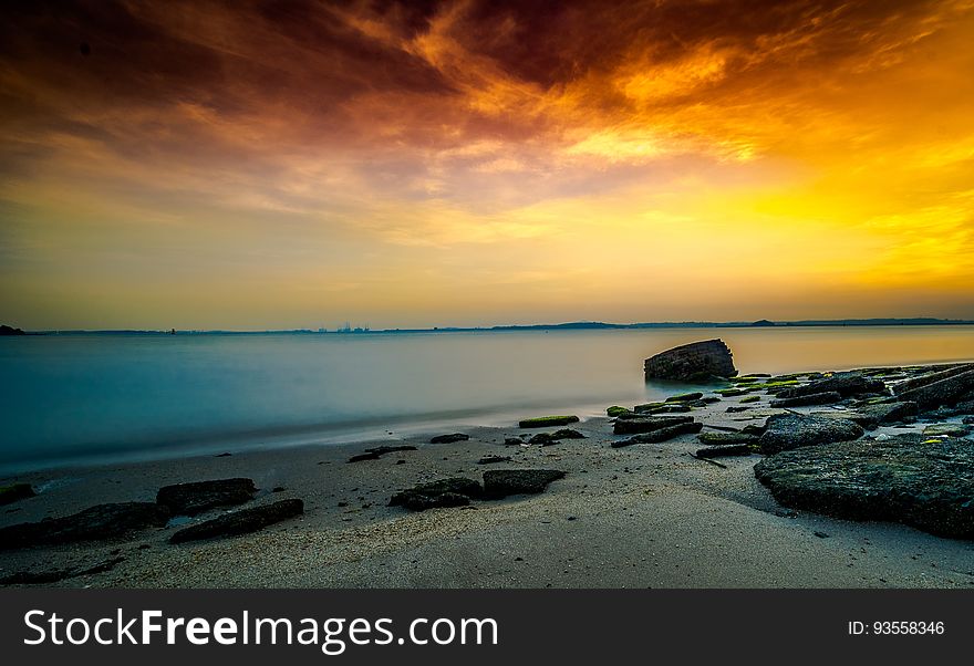 A beautiful beach sunset over tranquil waters. A beautiful beach sunset over tranquil waters.