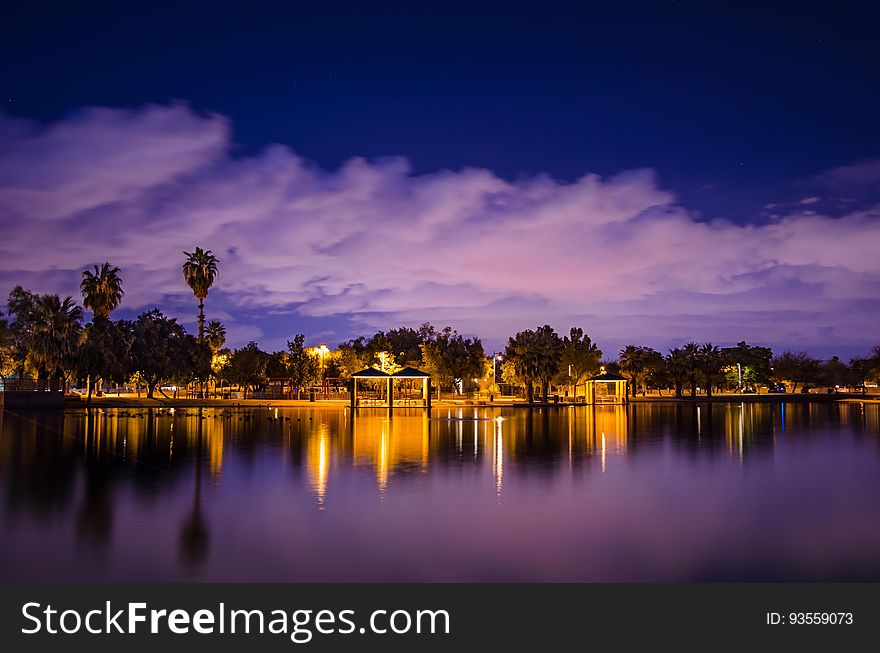 Lights on the shore of a lake at dusk. Lights on the shore of a lake at dusk.