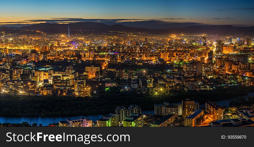 A panoramic view of a city at dusk. A panoramic view of a city at dusk.