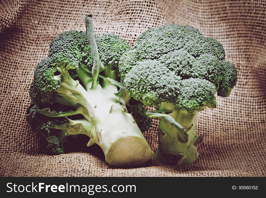 Closeup of broccoli on a burlap sack.