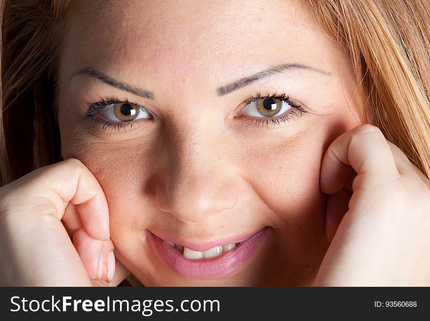 Closeup portrait of pretty young girl (teenager perhaps) highly intelligent and with brown eyes and blond hair.