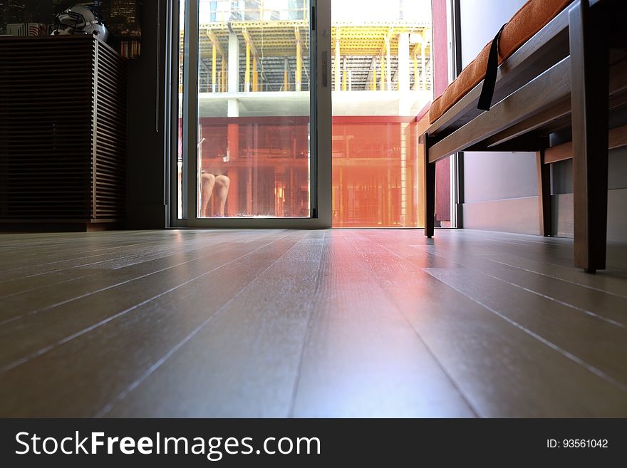A wooden floor leading to an outside balcony. A wooden floor leading to an outside balcony.