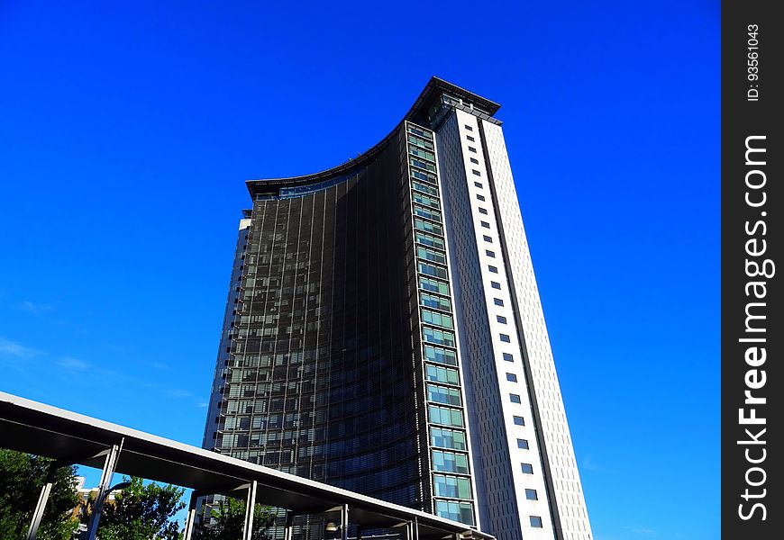 A high rise building, hotel or apartment block against the blue sky.