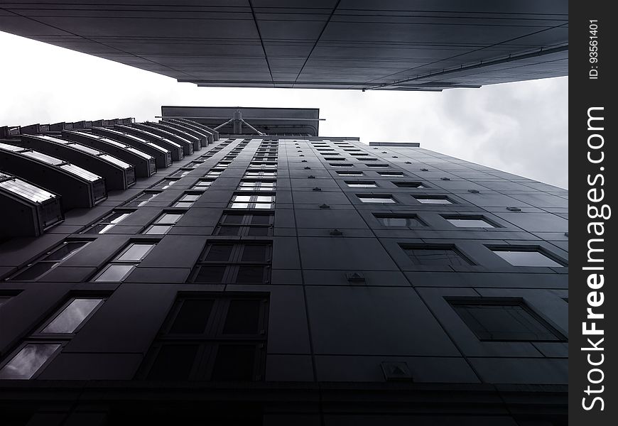 A low angle view of buildings and the sky between them. A low angle view of buildings and the sky between them.