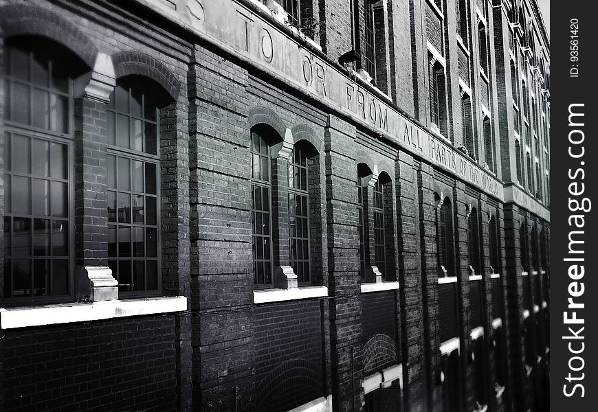 A black and white photo of a brick building.