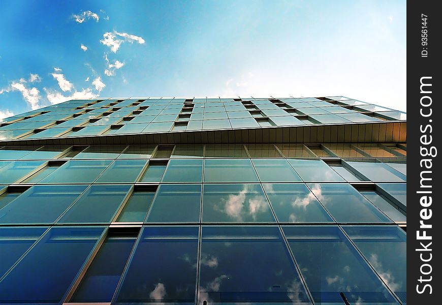 Angled view of a modern, glass building. Angled view of a modern, glass building.