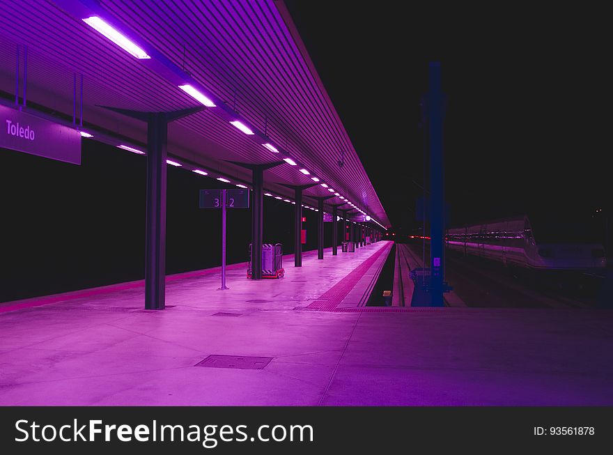 A railway station or a metro platform in purple colored lighting. A railway station or a metro platform in purple colored lighting.