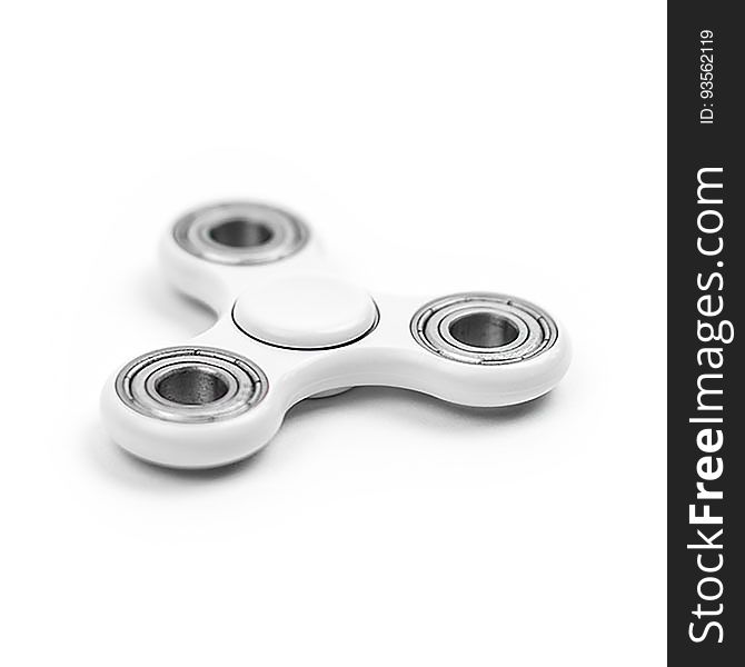 A close up of a white fidget spinner on white background.