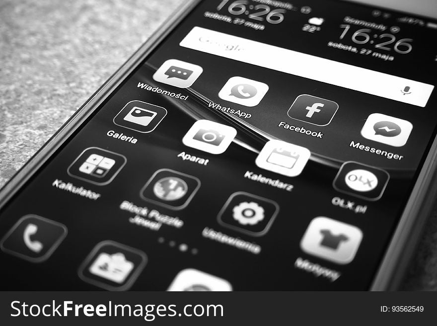 Apps on screen of smartphone in black and white.