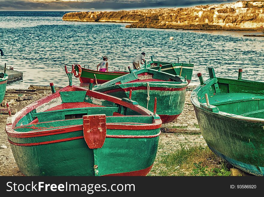 Green rowing boats on the beach